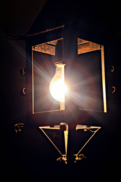 light from old rusty metal wall lamp - Photo, Image