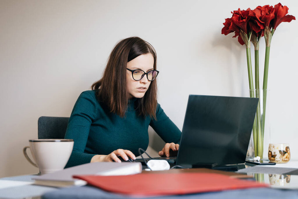 concentrated woman working at home during self isolation time, remote work - Photo, Image