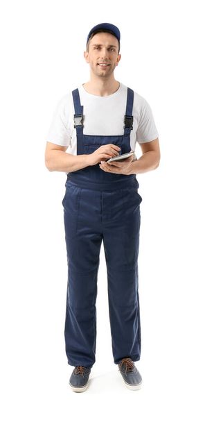 Male truck driver with tablet computer on white background - Photo, Image