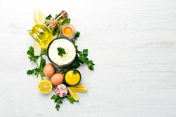 Homemade mayonnaise sauce and ingredients on white wooden background. Top view. Free space for your text. - Φωτογραφία, εικόνα