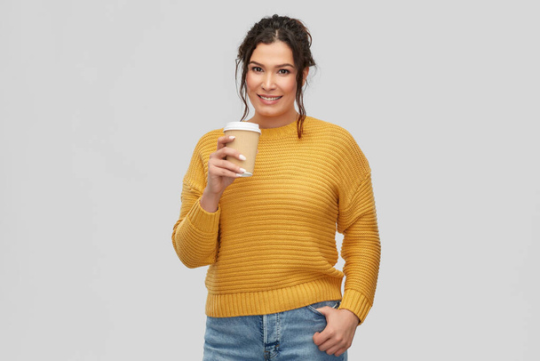 smiling woman with pierced nose holding coffee cup - Photo, image