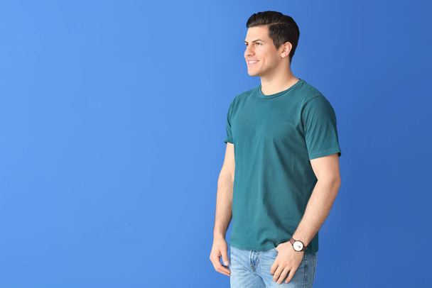 Man in stylish t-shirt on color background - Photo, Image