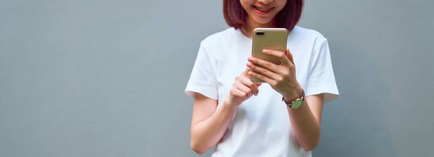 Close-up of woman holding a smartphone and using online social on lifestyle. Technology for communication concept. - 写真・画像