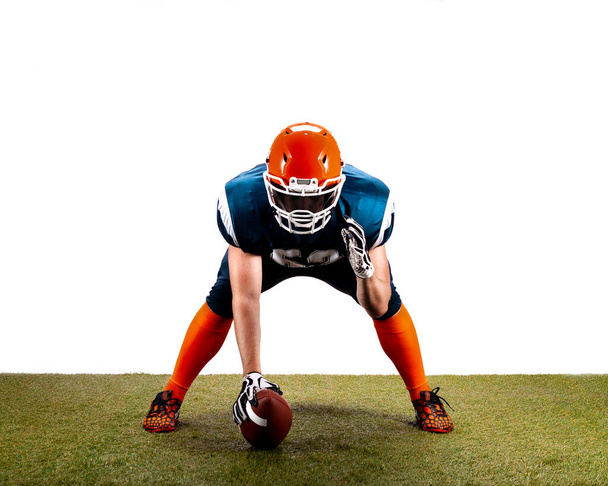 American football player with ball are ready to start on grass isolated on the white - Fotó, kép