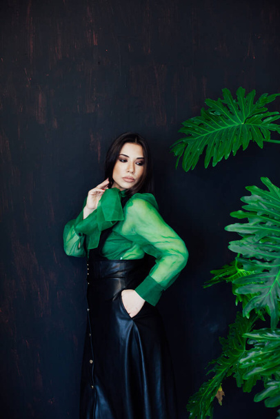 Beautiful fashionable oriental brunette woman in black green dress - Фото, зображення