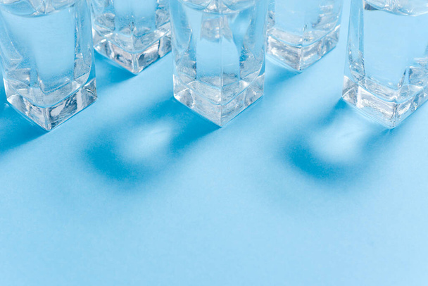 Glasses of water on blue. Close up. Copy space. Water balance for healthy and detox. - Foto, Bild