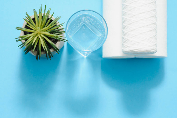 A glass of water on the background of filter cartridges - Photo, Image