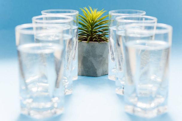 Drinking water. Fresh water in glasses on blue background - Foto, Imagen