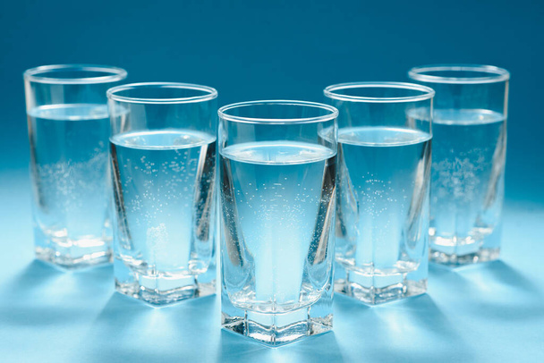 glasses with water on blue background. clean water concept - Fotoğraf, Görsel