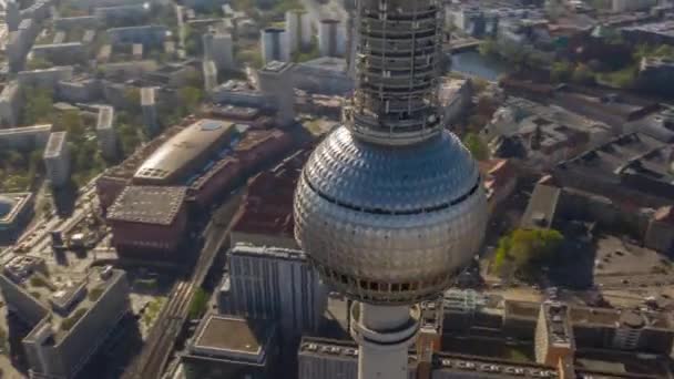 AERIAL: Close up Fast Drone Hyper Lapse, Motion Time Lapse Circling Alexander Platz TV Tower in Berlin, Germany in bright Summer Day - Felvétel, videó