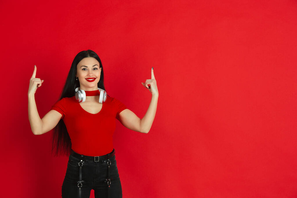 Caucasian young womans monochrome portrait on red studio background, emotional and expressive - Fotó, kép