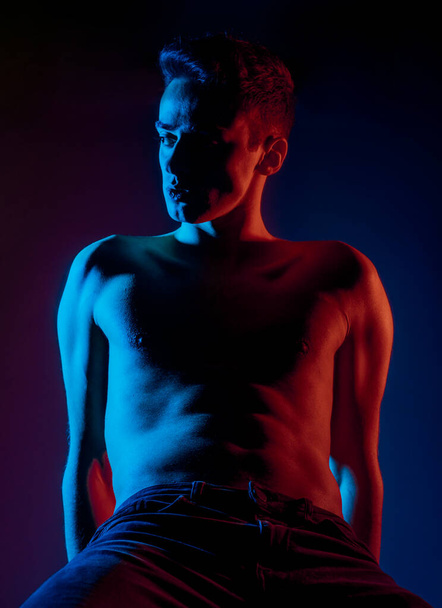 Studio body shot of a trendy young man wearing modern style jeans - Fotografie, Obrázek
