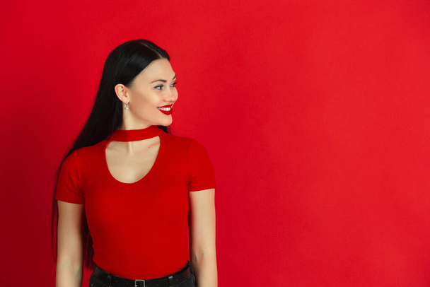 Caucasian young womans monochrome portrait on red studio background, emotional and expressive - Fotografie, Obrázek