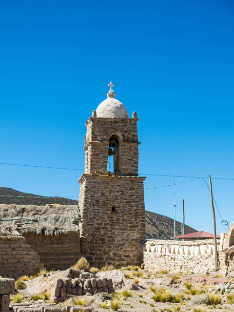 Stone church of the village of Sajama. The small Andean town of Sajama, Bolivian Altiplano. Its main economic activity is llama grazing and mountain tourism. South America - Photo, Image