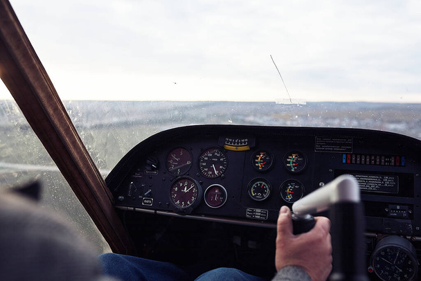 Unknown man flies a plane, close-up. Control Panel. Pilot controls gyroplane.  - Foto, Bild