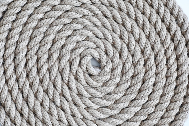 Braided thick rope tied in a skein. Hemp rope for decoration and design. Background from fishing rope. - Foto, imagen