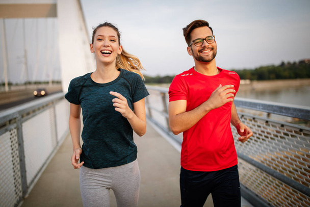 Young people jogging and exercising. Living healthy sporty lifestyle - Foto, Bild