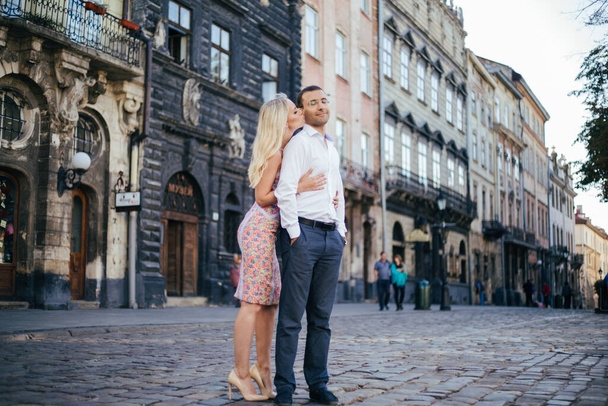 walking down the street together. Happy young man and smiling woman walking through the streets of Old Town, - Foto, Bild