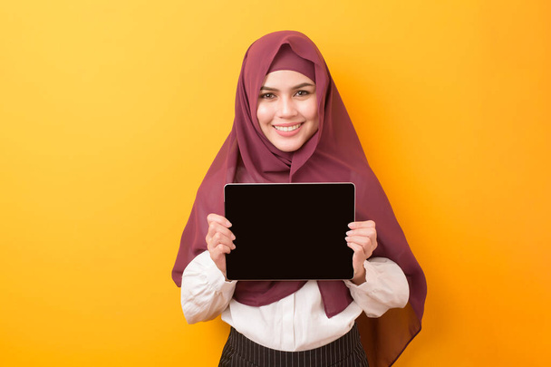 Beautiful University student with hijab portrait on yellow background  - Photo, Image