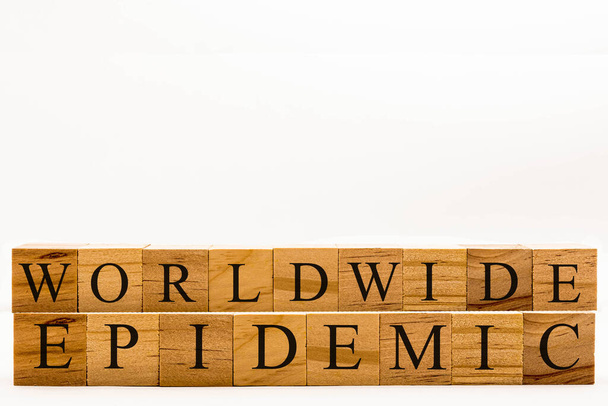 Coronavirus concept showing wooden blocks on a white background reading Worldwide Epidemic - Foto, immagini