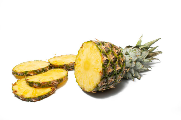 Fresh pineapple on a white background. Sliced exotic fruit waiting to be eaten. - 写真・画像