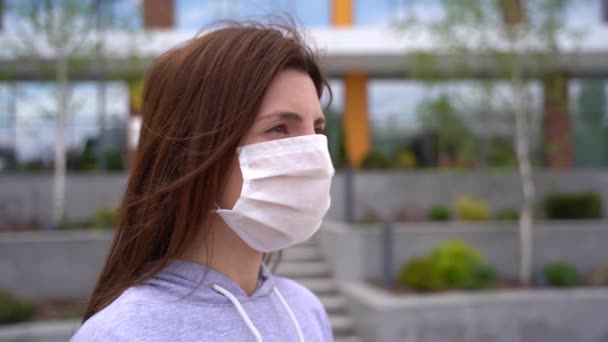 health, safety and pandemic concept - young woman wearing protective medical mask  - 映像、動画