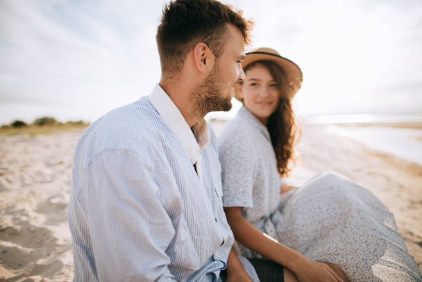 Portrait of young man and young woman on morning sea beach. Summer vacation concept - Photo, Image