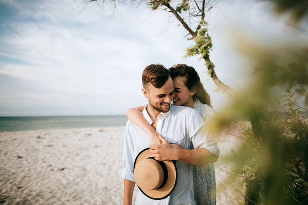 Young loving couple hugging on the sea beach. Love concept - Photo, image