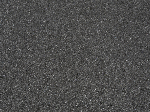 Schwarze Mikroschwamm-Textur. Hintergrund aus weichem Gummi mit hoher Auflösung, geeignet für grafische Ansicht von oben. - Foto, Bild