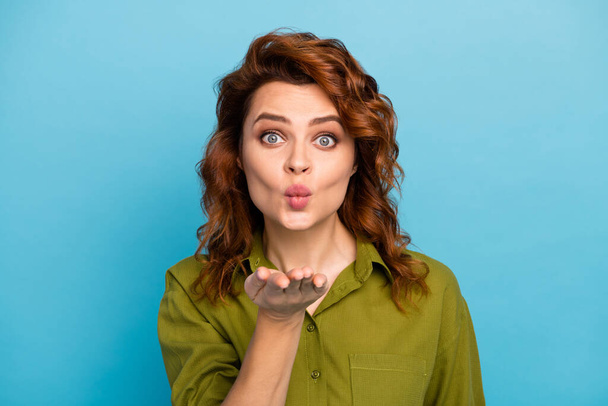 Portrait of lovely nice romantic woman want attract guy send funny air kiss hold hand wear stylish outfit isolated over blue color background - Foto, immagini