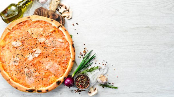 Pizza with salmon and tomato sauce. Italian cuisine. Food delivery. Top view. - Foto, immagini