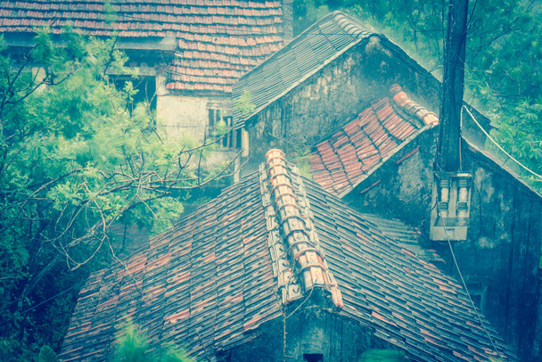 Filtered image top view heavy rain and windy over ancient tile roof at remote village in the North Vietnam - Photo, Image