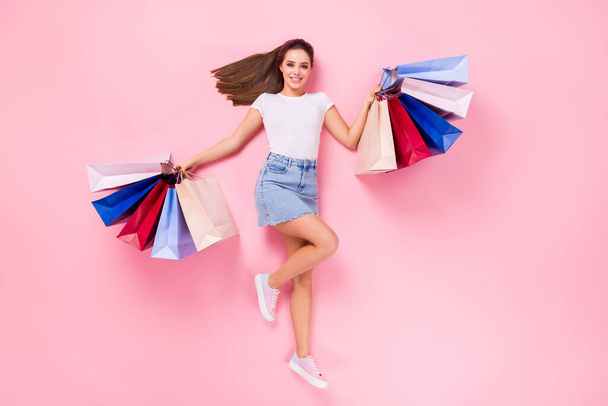 Top above high angle view full length photo of cheerful cute girlish girl hold shopping bags enjoy buying boutique lay wear good look clothes isolated pastel color background - Zdjęcie, obraz