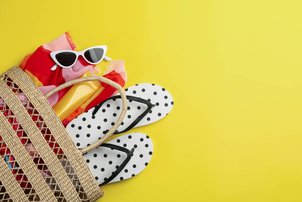 Bag with beach accessories on yellow background, flat lay. Space for text - Fotoğraf, Görsel