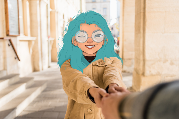 selective focus of girl with illustrated smiling face and blue hair holding hand of man in city - Photo, Image