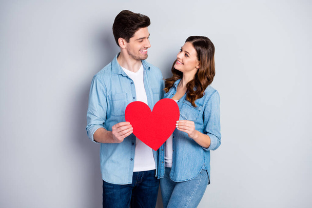 Photo two people charming lady handsome guy demonstrating per paper heart figure postcard symbolizing love wear casual denim shirts outfit isolated grey color background - Foto, immagini