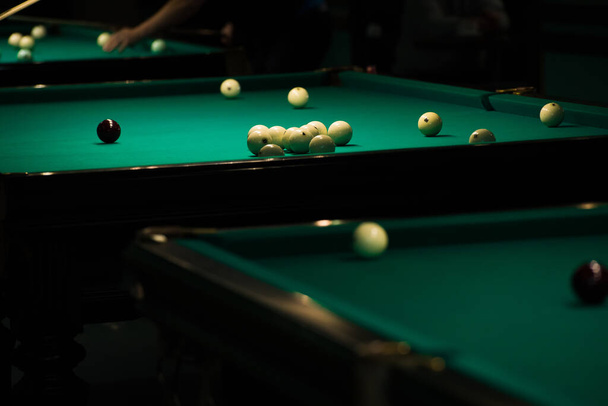 Sports game of billiards on a green cloth. Billiards white billiard balls close up - Фото, изображение