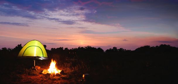Camping tent near small bonfire in twilight. Banner design - Fotó, kép