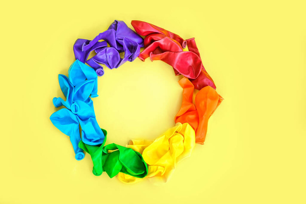 LGBT flag painted isolated on a yellow background. Multi-colored LGBT symbol of colored balls. Copy space, banner - Photo, Image