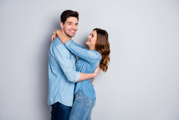 Portrait of positive passionate married couple woman man hug embrace enjoy together wear casual style clothes isolated over gray color background - Фото, изображение