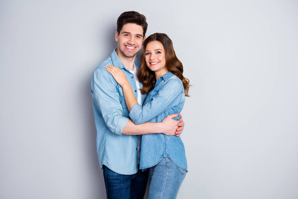 Photo lady guy couple in love stand cuddle hugging together holding hands romantic feelings date wear casual denim shirts outfit isolated grey color background - Foto, Imagem