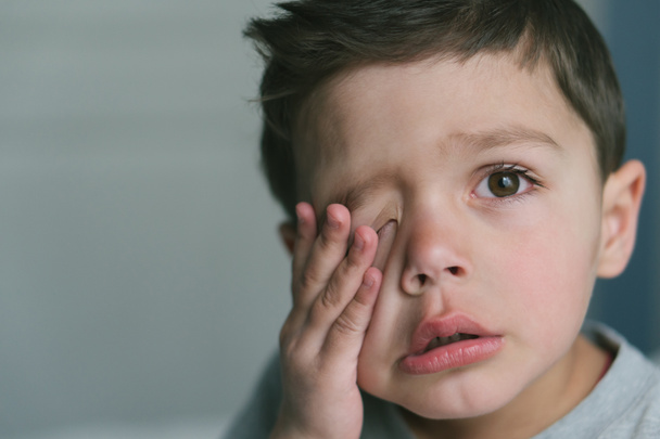frustrated toddler boy touching face at home  - Photo, Image