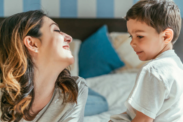 cheerful mother looking at cute toddler son - Photo, image