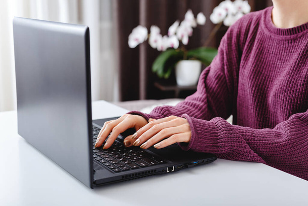 Woman working or learning from home using laptop. Freelancer have remote work, online education, work on maternity leave. Female hands typing on keyboard at home office - Φωτογραφία, εικόνα