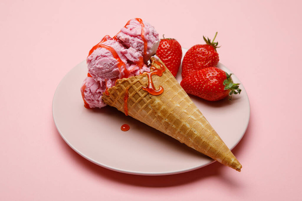 Ice cream cone strawberry flavors on a pink background. - Фото, изображение