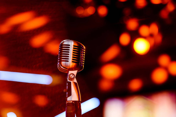 Karaoke background.Silver vintage microphone on bokeh.Close-up of retro microphone at concert.Professional microphone - Photo, Image