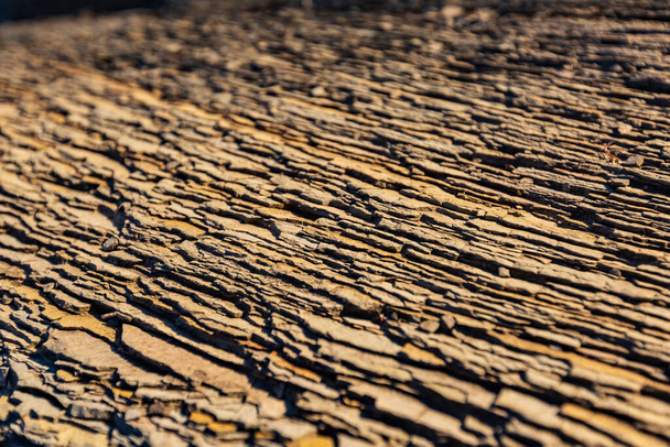 texture of a stone uneven surface under sunlight on nature. Horizontal orientation. High quality photo - Valokuva, kuva