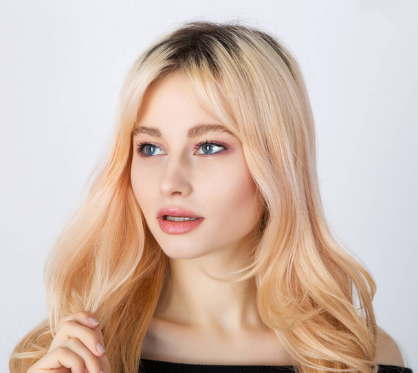 Portrait of a blond girl with overgrown dark roots. - Zdjęcie, obraz