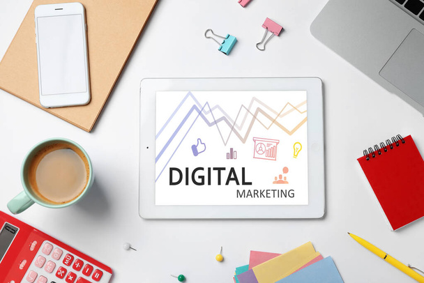 Digital marketing concept. Modern tablet on workplace, flat lay - Fotó, kép