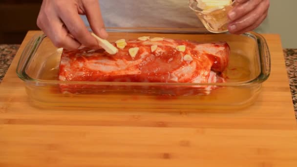 putting pieces of butter in a piece of pork tender loin - Footage, Video